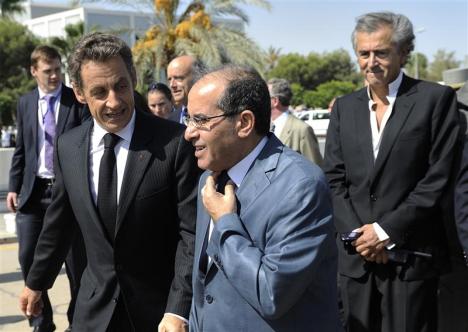 France's President Sarkozy speaks with (NTC) Prime Minister Mahmoud Jibril as they walk to Medical Center in Tripoli